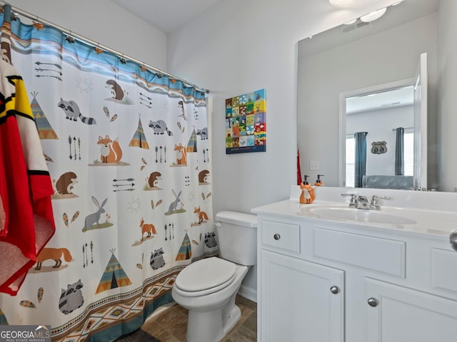 bathroom with vanity, toilet, and a shower with shower curtain