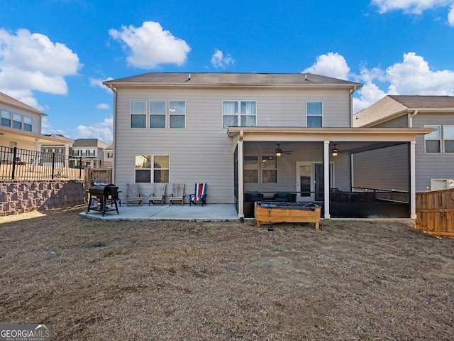 back of house with ceiling fan and a patio area