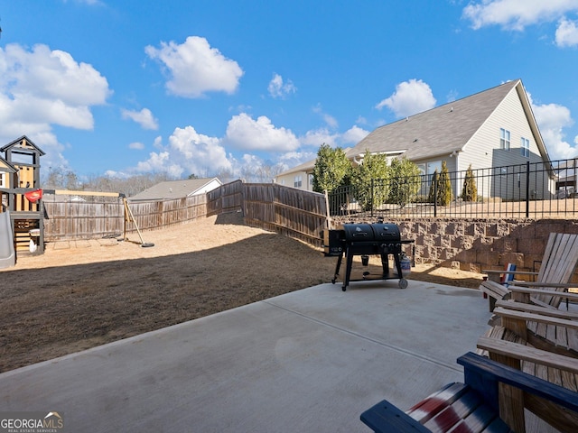 view of patio with a grill and a playground