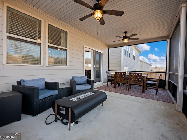 view of patio / terrace with an outdoor living space with a fire pit and ceiling fan