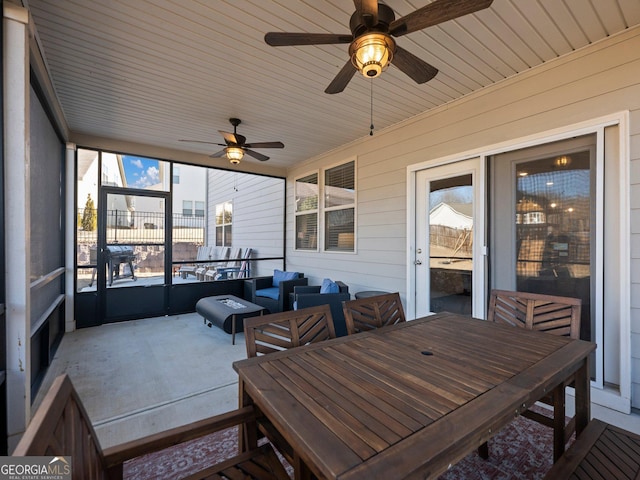 sunroom featuring ceiling fan