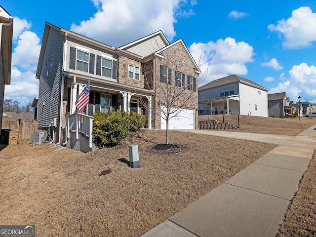 view of front of house with cooling unit and a garage