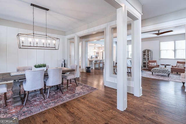 dining area featuring dark hardwood / wood-style floors and a notable chandelier