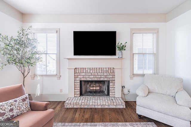 living room with dark hardwood / wood-style floors and a fireplace