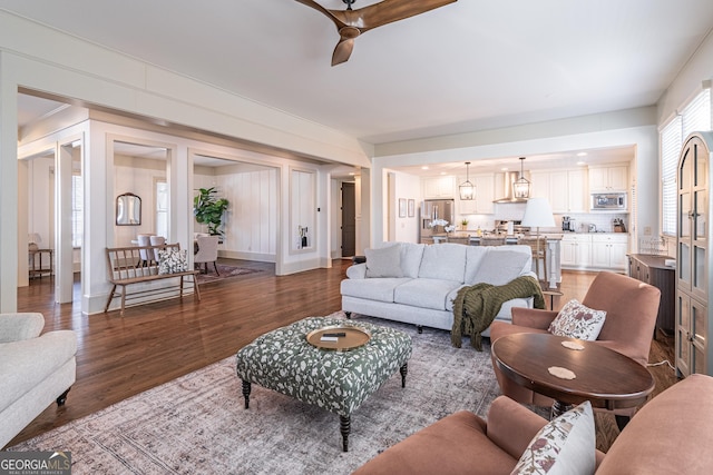 living room with hardwood / wood-style floors and ceiling fan