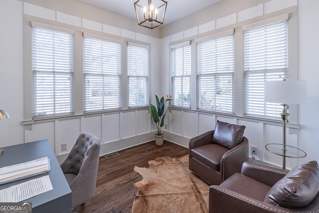 home office featuring a notable chandelier and dark hardwood / wood-style floors