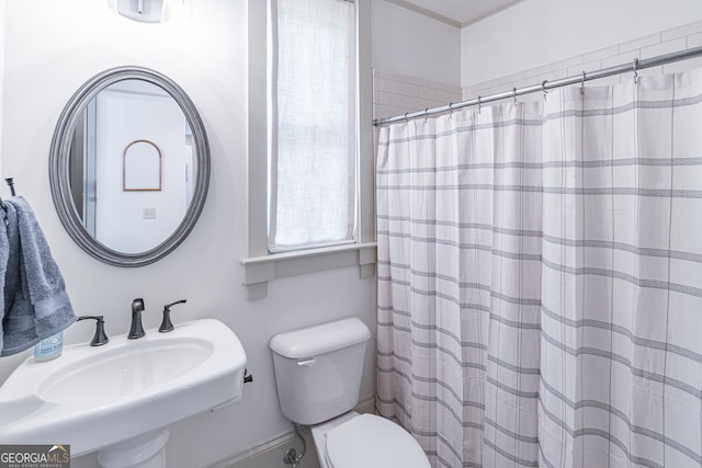 bathroom with sink, a shower with curtain, and toilet