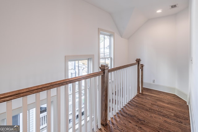 hallway featuring vaulted ceiling and dark wood-type flooring