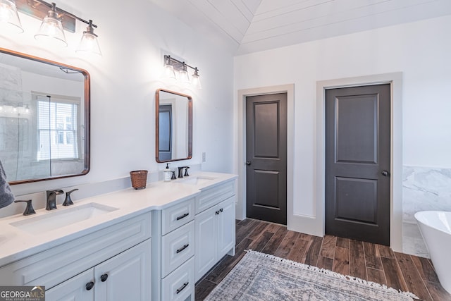 bathroom with vanity, lofted ceiling, wooden ceiling, and a tub to relax in