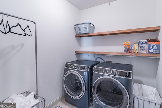 laundry area with separate washer and dryer and light tile patterned floors