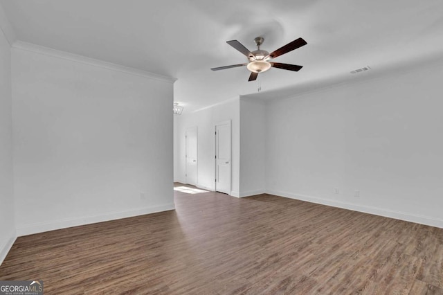 empty room featuring ceiling fan, dark wood-type flooring, and ornamental molding