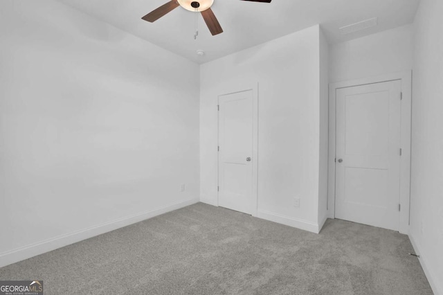 unfurnished bedroom with ceiling fan and light colored carpet