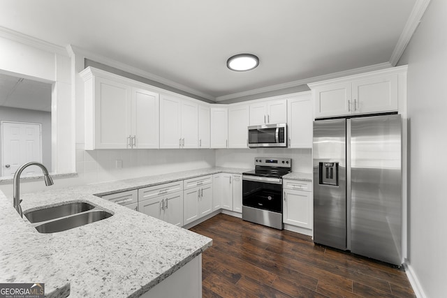 kitchen with dark wood-type flooring, white cabinetry, stainless steel appliances, sink, and light stone counters