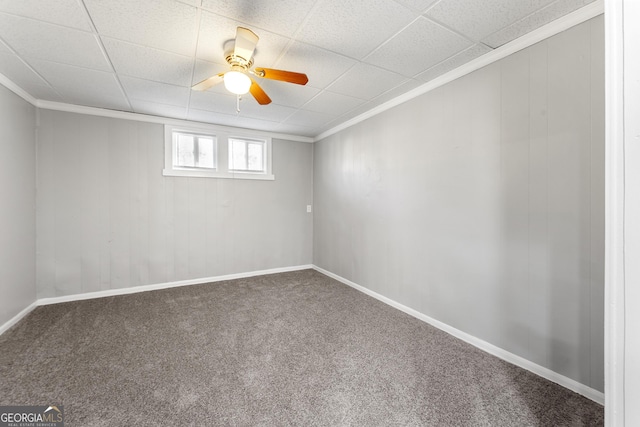 carpeted spare room with crown molding and ceiling fan