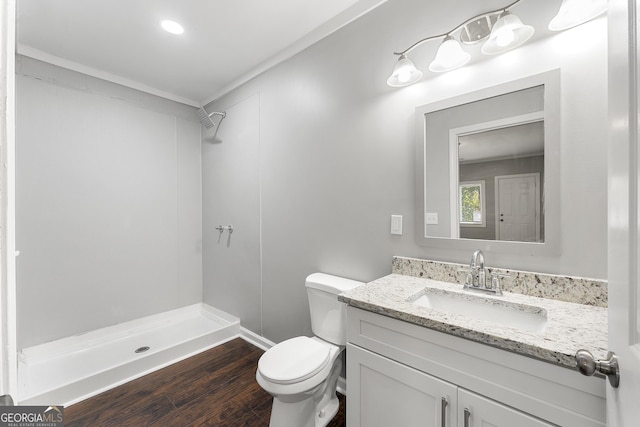 bathroom with wood-type flooring, toilet, walk in shower, and vanity