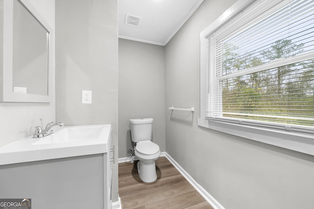 bathroom featuring plenty of natural light, hardwood / wood-style floors, toilet, and vanity