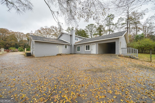 rear view of house with a garage