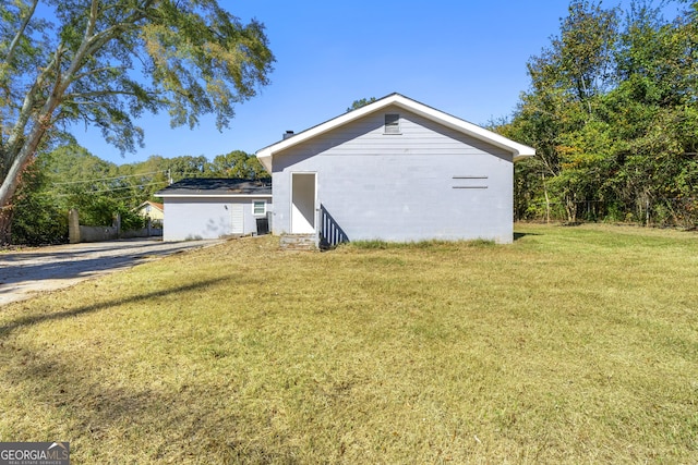 view of property exterior featuring a lawn