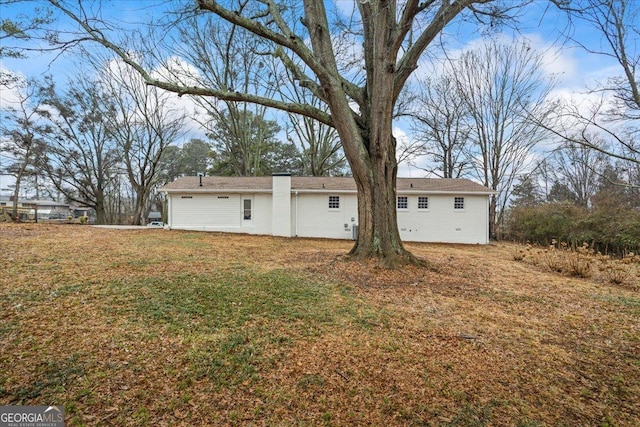 rear view of house with a lawn