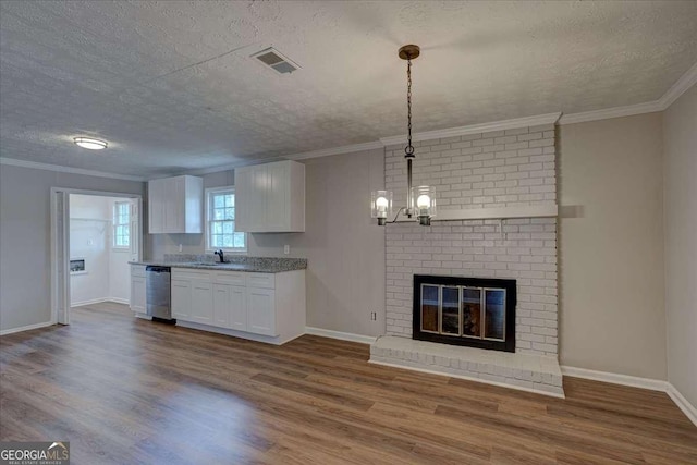 kitchen featuring crown molding, hanging light fixtures, hardwood / wood-style floors, white cabinets, and stainless steel dishwasher