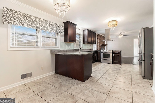 kitchen with ceiling fan with notable chandelier, island exhaust hood, light tile patterned floors, stainless steel appliances, and dark brown cabinets