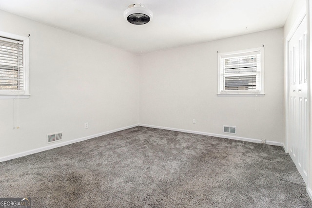 empty room featuring dark colored carpet