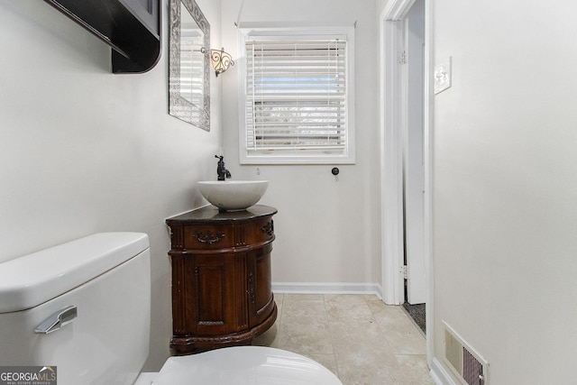 bathroom featuring tile patterned floors, vanity, and toilet