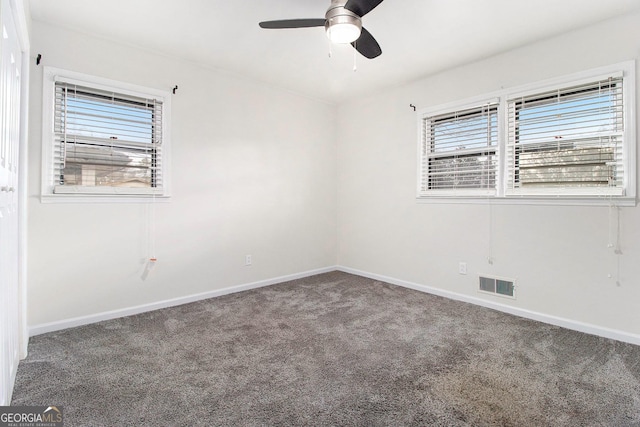 spare room featuring carpet floors and ceiling fan