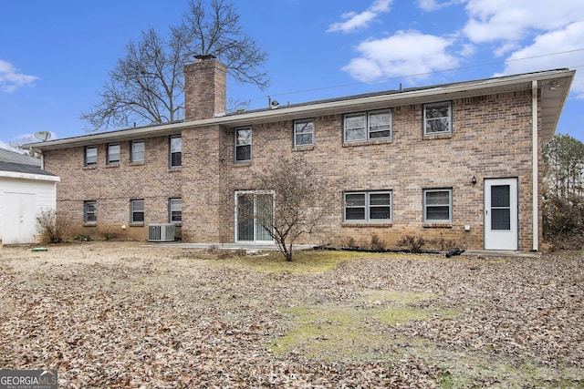 rear view of house featuring central AC