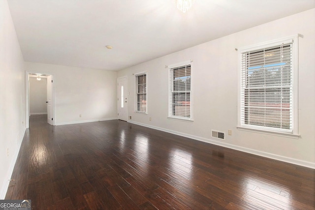 spare room with dark hardwood / wood-style floors