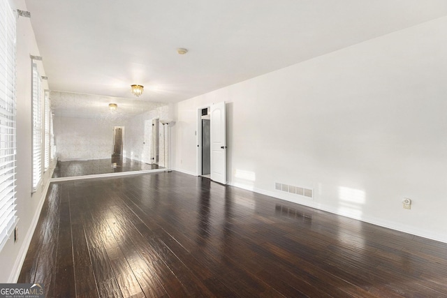 spare room featuring wood-type flooring