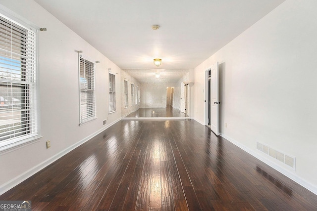 empty room featuring dark hardwood / wood-style flooring