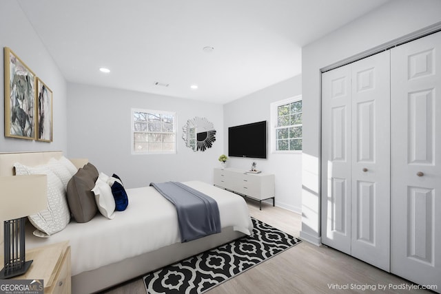 bedroom featuring light hardwood / wood-style flooring and a closet