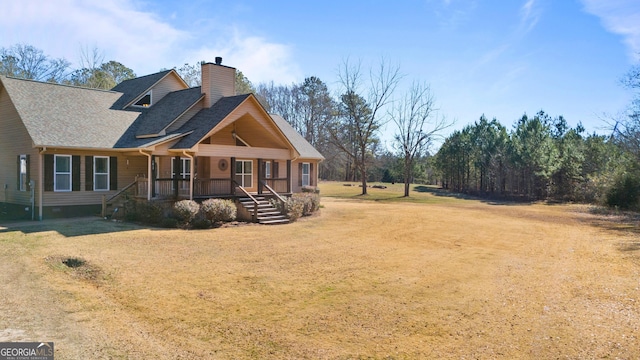 view of front of house featuring covered porch and a front lawn