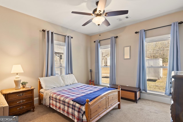 bedroom featuring multiple windows and ceiling fan