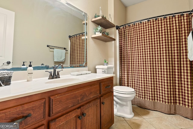 bathroom with tile patterned floors, vanity, and toilet