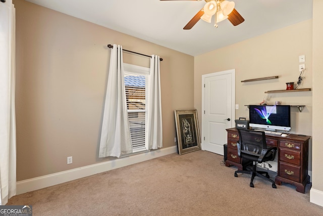 carpeted office space with ceiling fan