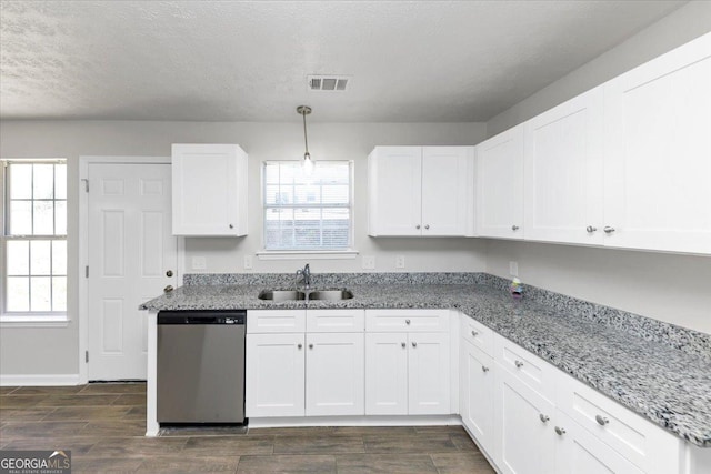 kitchen with light stone countertops, pendant lighting, dishwasher, white cabinetry, and sink