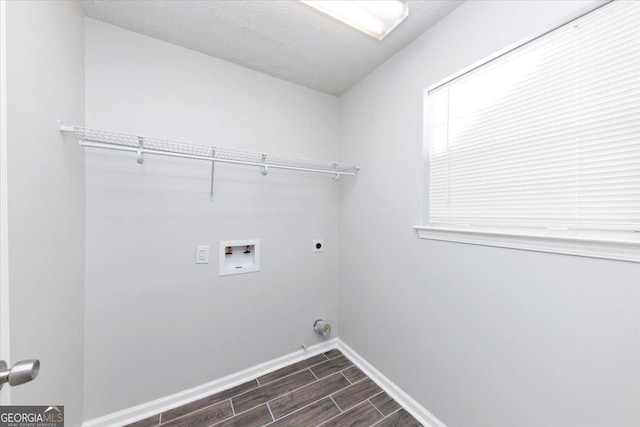 clothes washing area featuring washer hookup, a textured ceiling, and hookup for an electric dryer