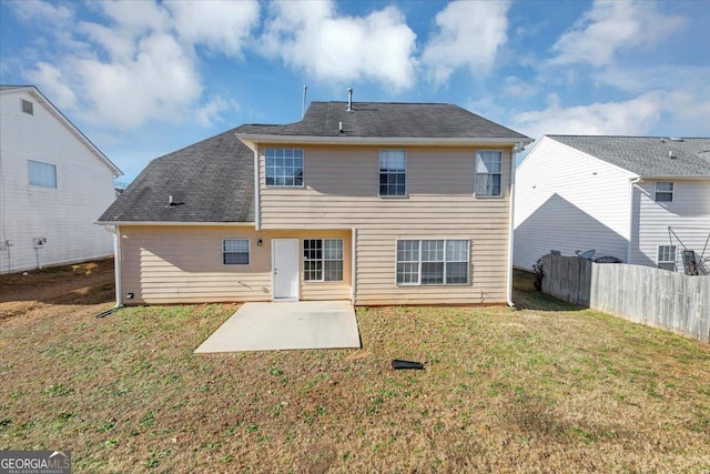 rear view of house featuring a lawn and a patio