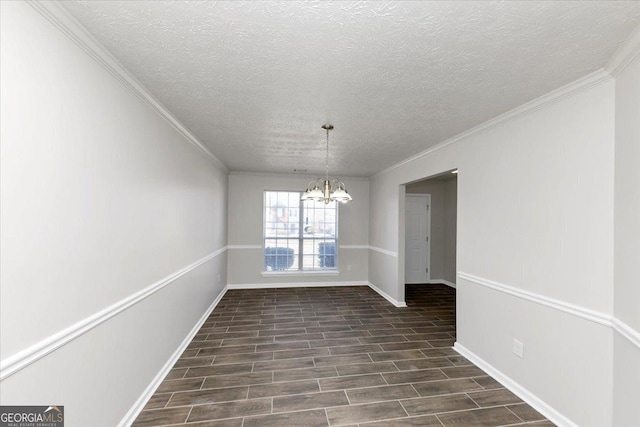 spare room with a notable chandelier, crown molding, and a textured ceiling