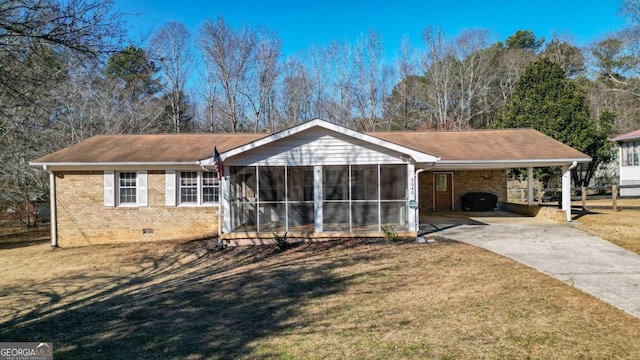 single story home featuring a front yard, a sunroom, and a carport