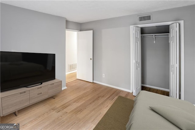 bedroom featuring a closet and light hardwood / wood-style floors