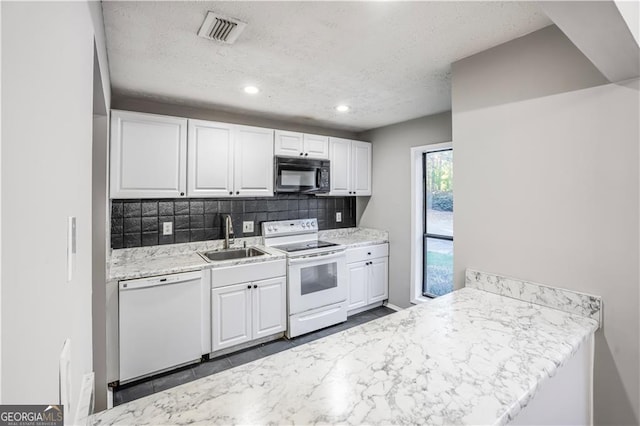 kitchen with sink, backsplash, white cabinetry, white appliances, and a textured ceiling