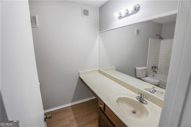 full bathroom with shower / bathtub combination, hardwood / wood-style flooring, toilet, and vanity