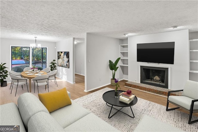 living room featuring hardwood / wood-style flooring, a textured ceiling, and an inviting chandelier