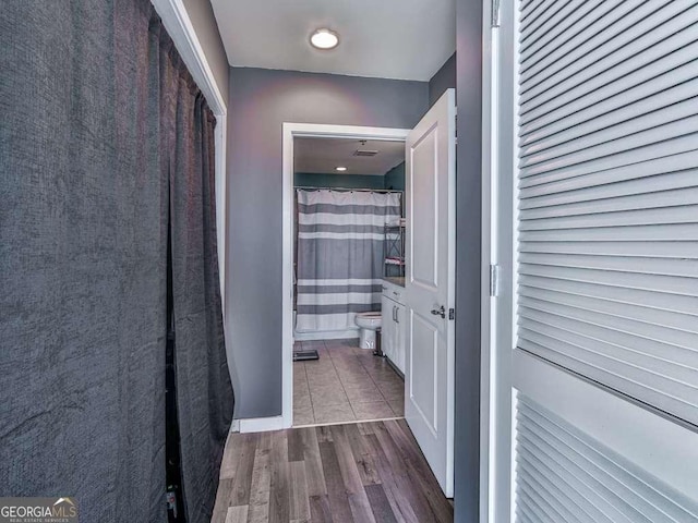 corridor featuring dark hardwood / wood-style flooring