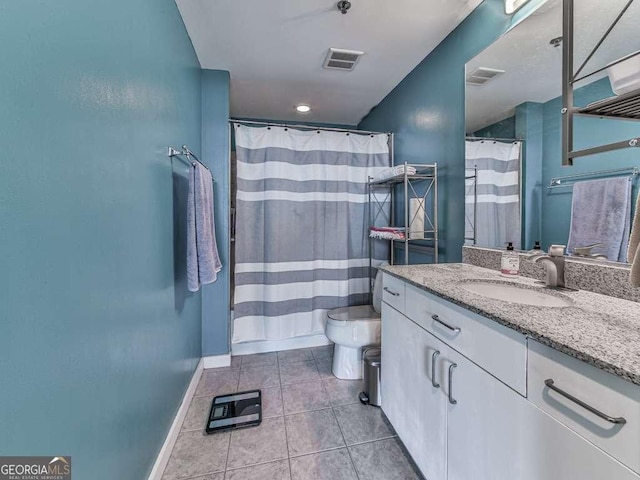 bathroom with toilet, tile patterned floors, and vanity