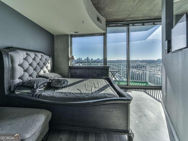 bedroom with wood-type flooring and floor to ceiling windows