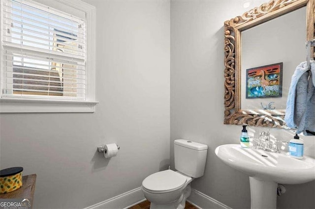 bathroom with a wealth of natural light and toilet